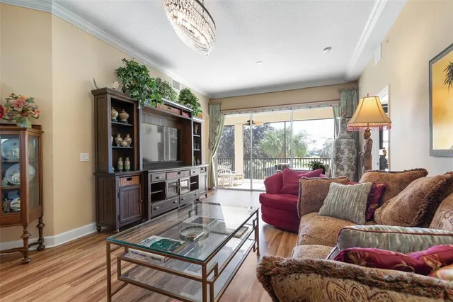 a view of a dining room with furniture large windows and wooden floor