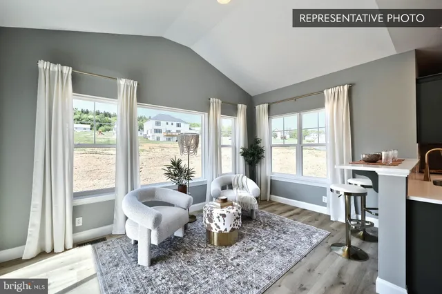 a living room with furniture floor to ceiling window and a flat screen tv