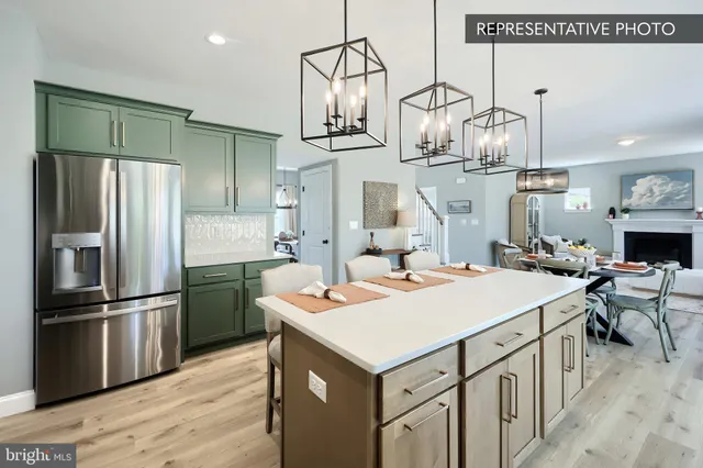 a kitchen that has a lot of cabinets and refrigerator in it