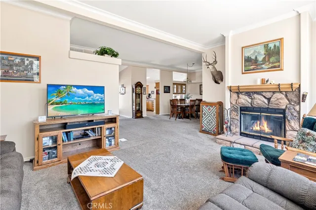a view of a dining room with furniture and a chandelier