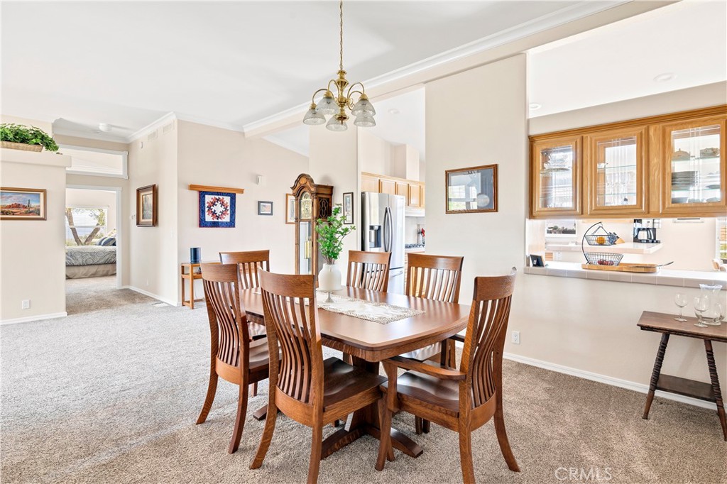 39597 Calle Escalona Temecula, CA 92592 - Photo 16 of 61 a view of a dining room with furniture and a chandelier