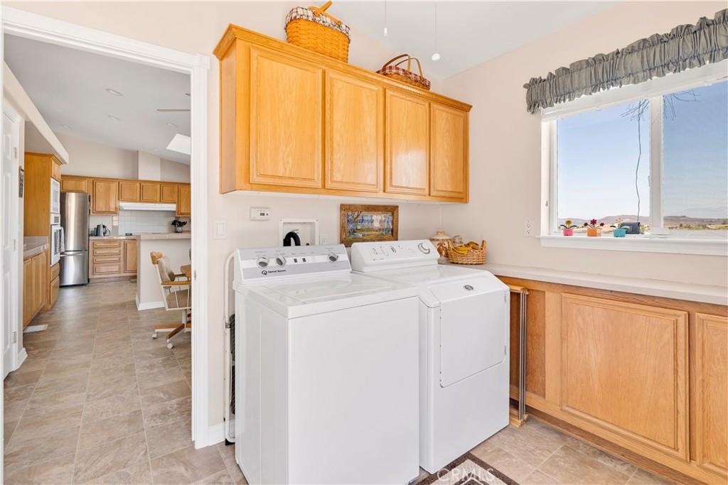 39597 Calle Escalona Temecula, CA 92592 - Photo 23 of 61 a utility room with dryer and washer