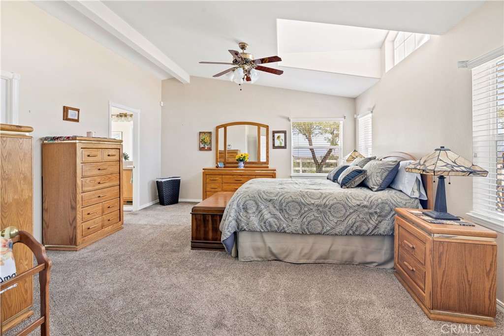 39597 Calle Escalona Temecula, CA 92592 - Photo 24 of 61 a spacious bedroom with a bed and a chandelier