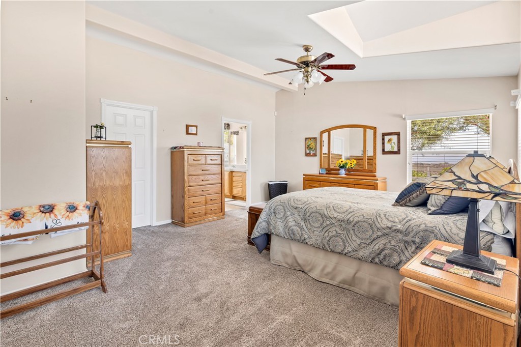 39597 Calle Escalona Temecula, CA 92592 - Photo 25 of 61 a bedroom with a bed and a chandelier