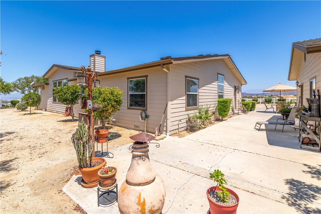39597 Calle Escalona Temecula, CA 92592 - Photo 37 of 61 a view of a backyard with table and chairs potted plants