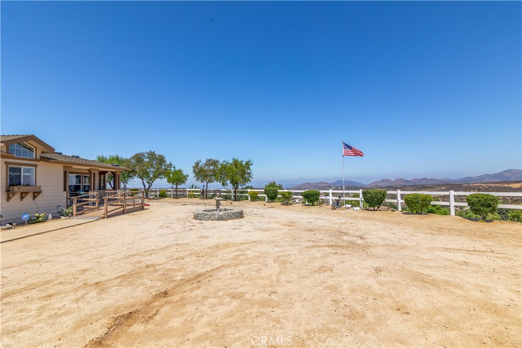 39597 Calle Escalona Temecula, CA 92592 - Photo 9 of 61 a swimming pool with lawn chairs and large tree