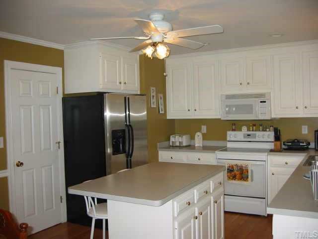 760 Mitchell Road Angier, NC 27501 - Photo 4 of 12 a kitchen with a sink a refrigerator and cabinets
