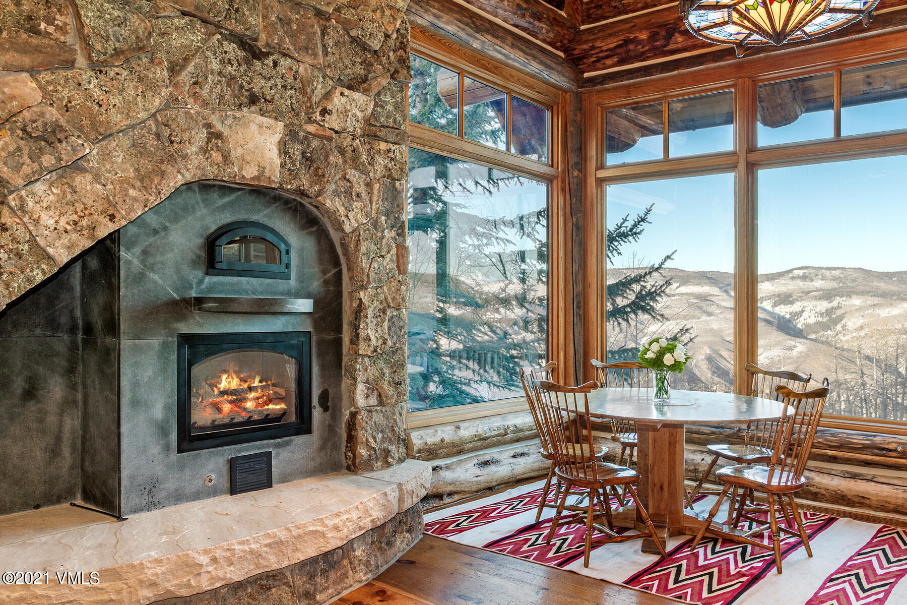 2291 Daybreak Ridge Road Avon, CO 81620 - Photo 11 of 56 a living room with furniture a floor to ceiling window and floor to ceiling windows