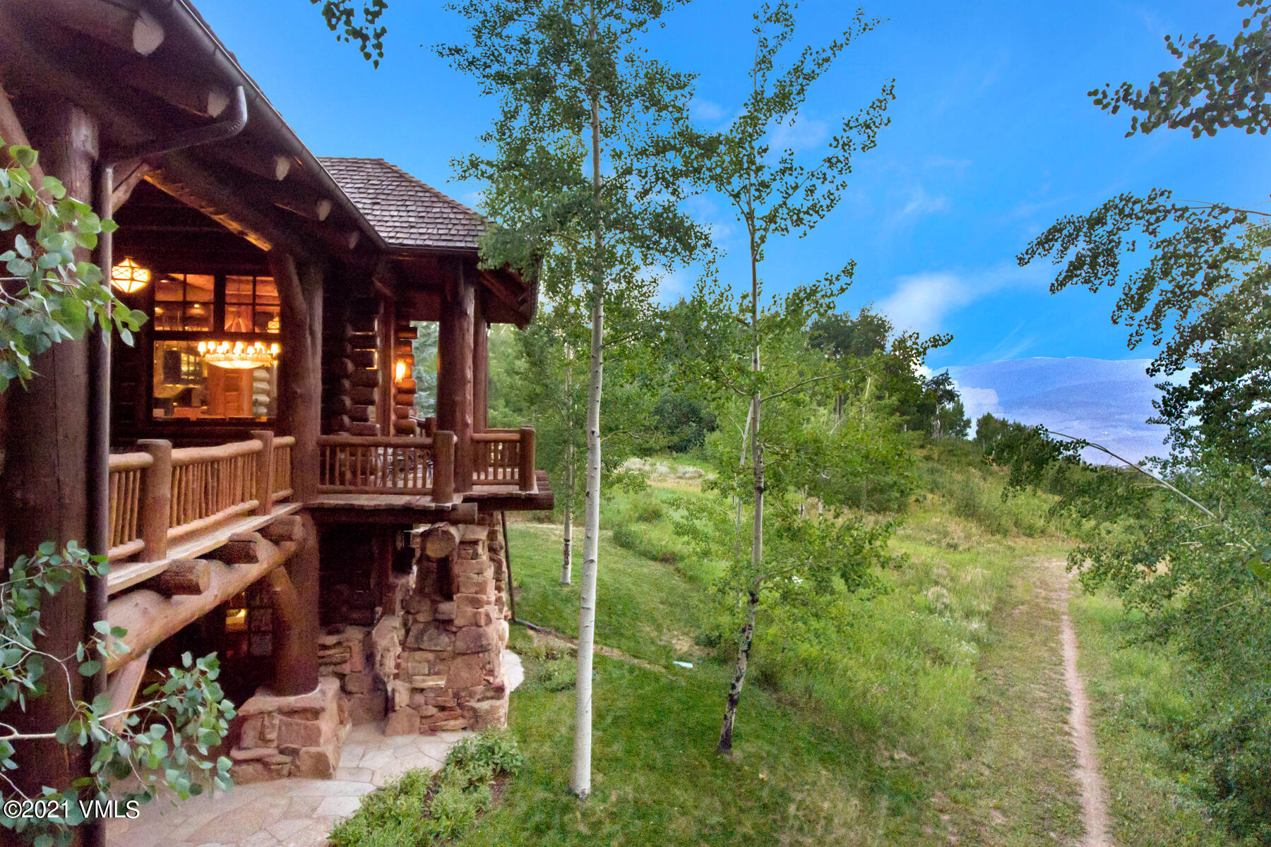 2291 Daybreak Ridge Road Avon, CO 81620 - Photo 18 of 56 a view of a patio with table and chairs potted plants with wooden fence