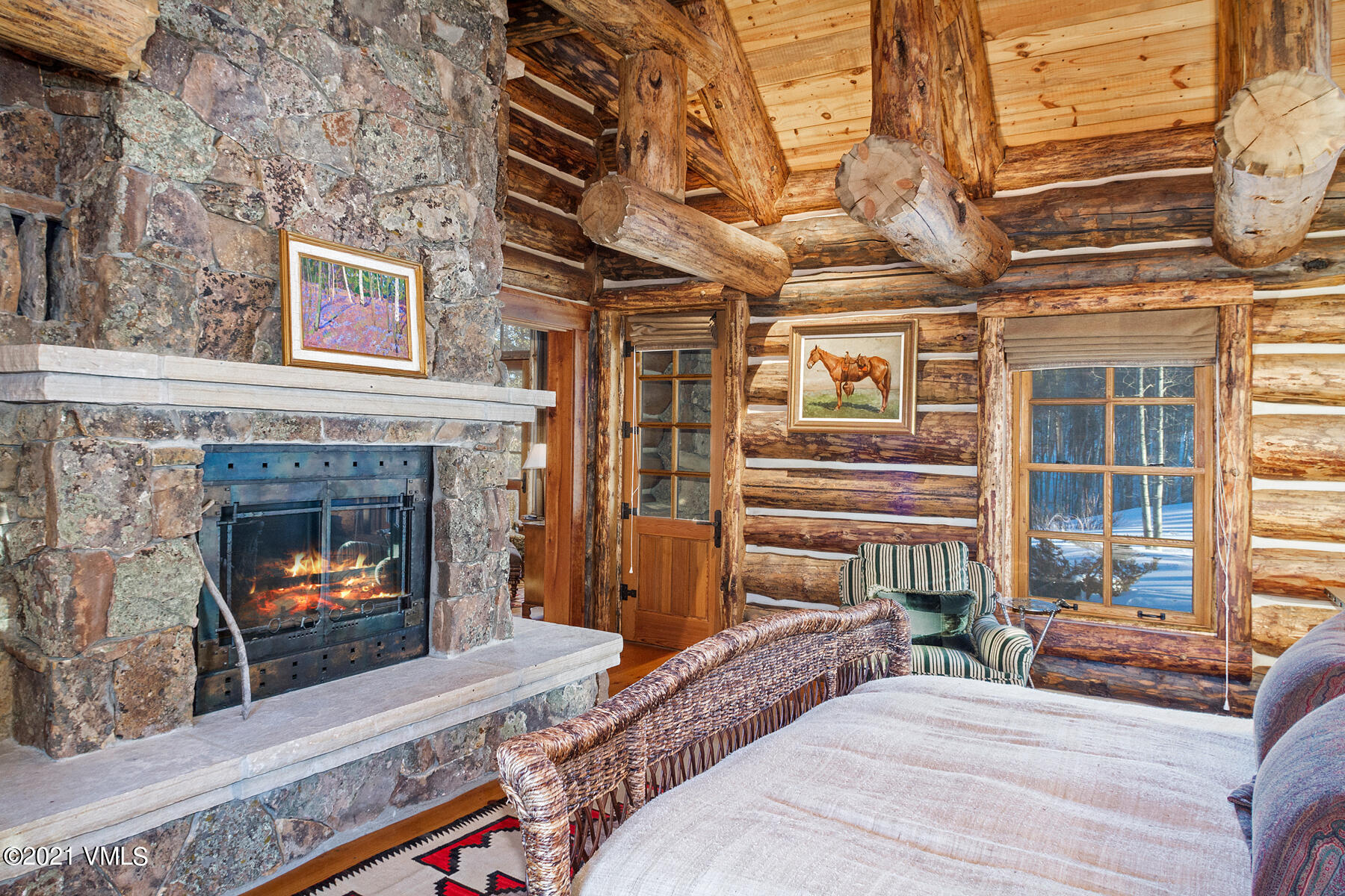 2291 Daybreak Ridge Road Avon, CO 81620 - Photo 27 of 56 a bedroom with a bed and a fireplace