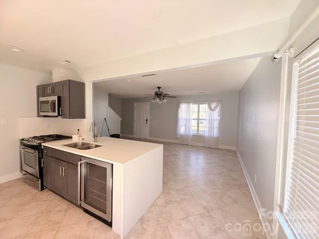 a view of a kitchen with a sink and a stove top oven