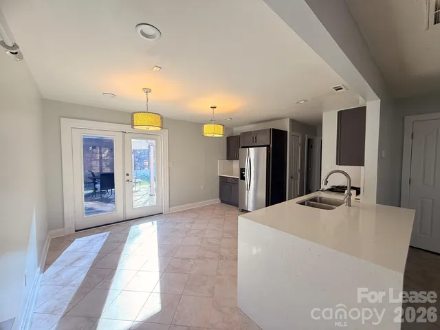 a view of kitchen with kitchen island a sink a refrigerator and a stove