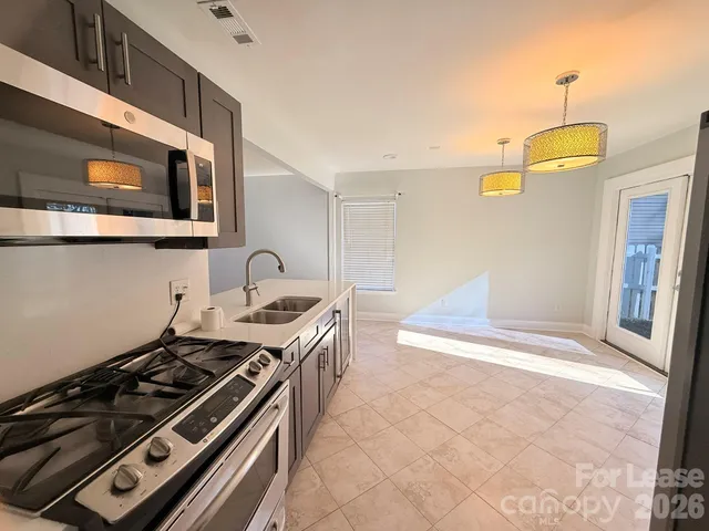 a kitchen with stainless steel appliances granite countertop a stove and a microwave