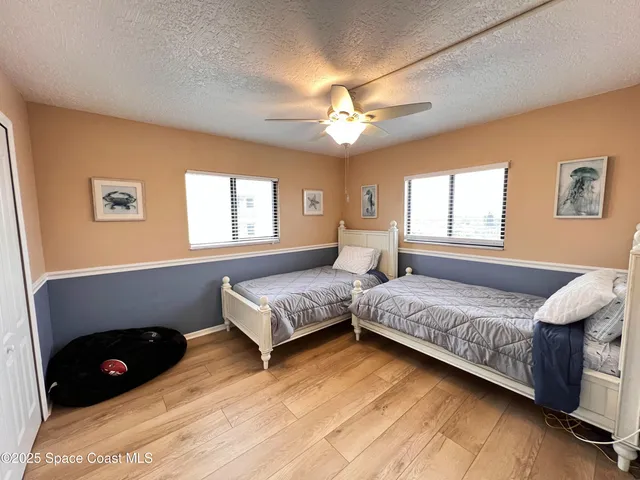a bedroom with a bed and a ceiling fan