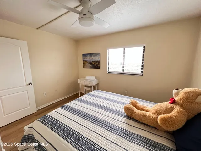 a bedroom with bed and a window