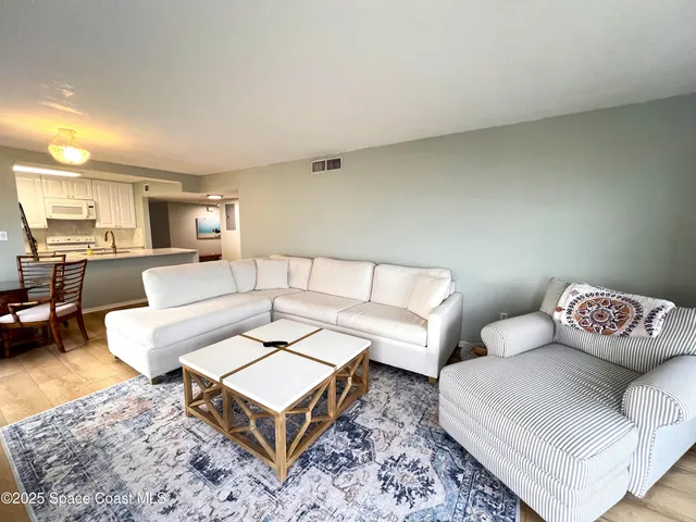 a living room with furniture and a rug