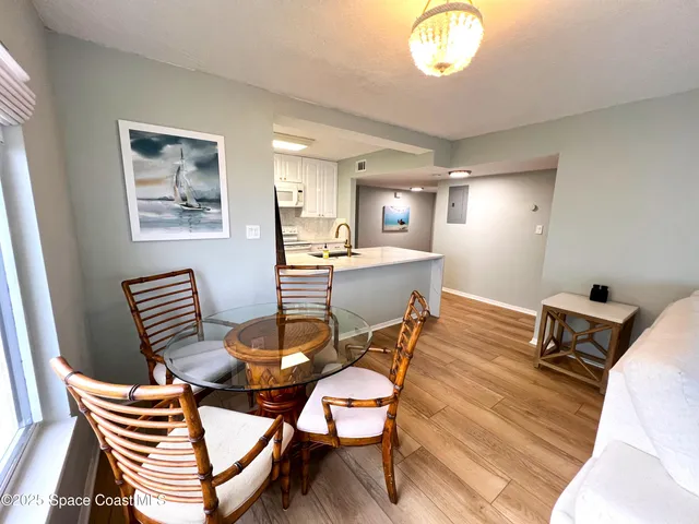 a dining room with furniture and chandelier