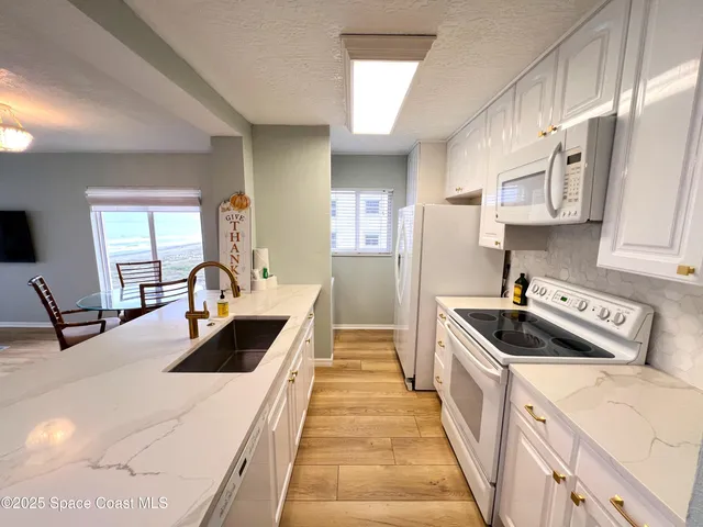 a kitchen with stainless steel appliances a sink stove and cabinets