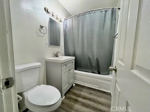 a bathroom with a sink a toilet a mirror and shower