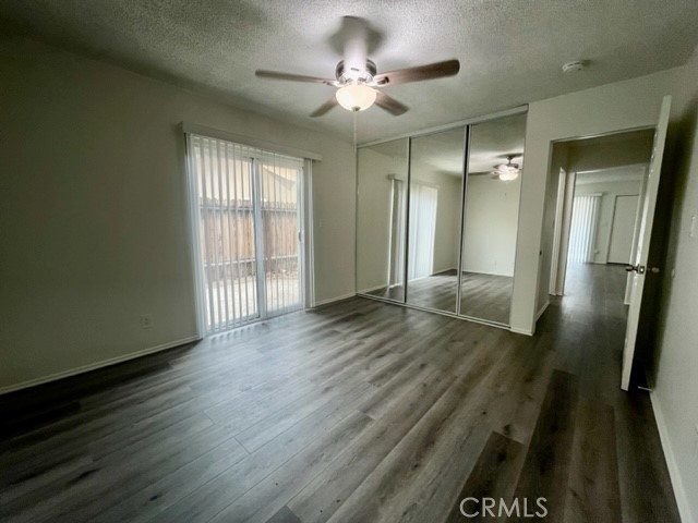 686 East Cottonwood Road, Unit 7 Palm Springs, CA 92262 - Photo 14 of 19 a view of an empty room with wooden floor and a window