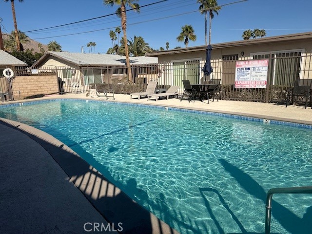 686 East Cottonwood Road, Unit 7 Palm Springs, CA 92262 - Photo 19 of 19 a view of a house with a backyard porch and sitting area
