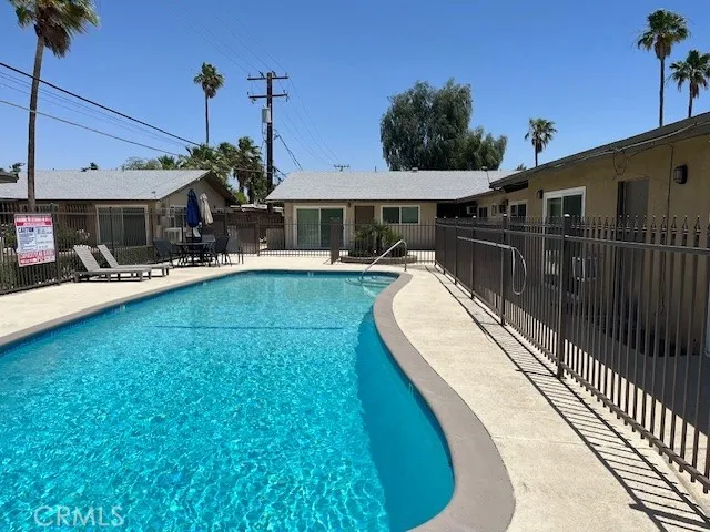 a view of a house with a backyard patio and sitting area