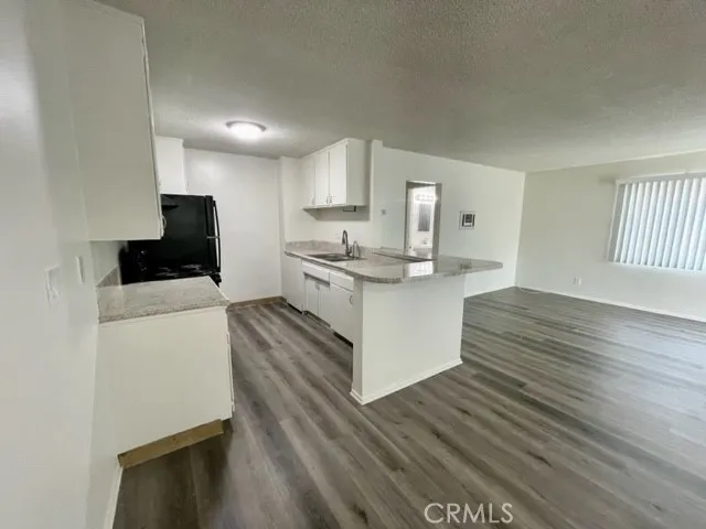 a kitchen with stainless steel appliances a stove top oven and a refrigerator