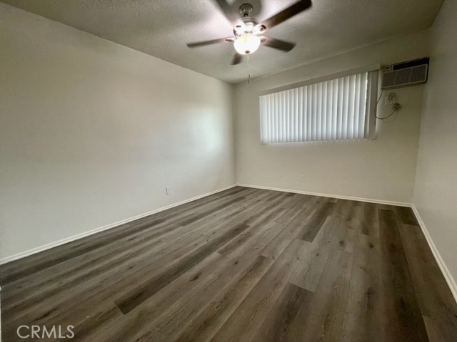 686 East Cottonwood Road, Unit 7 Palm Springs, CA 92262 - Photo 10 of 19 wooden floor in an empty room with a window