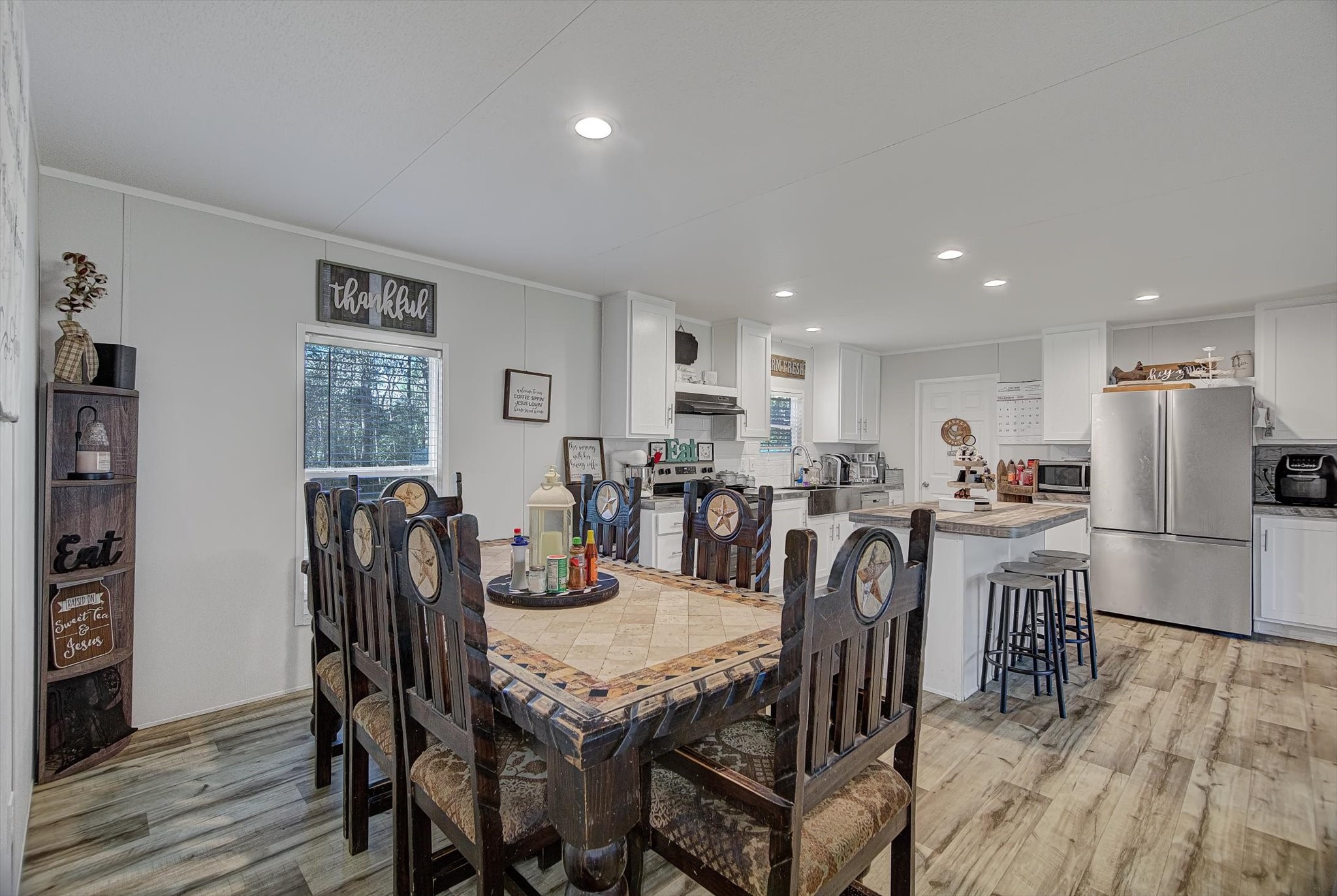 650 County Road 2219 Cleveland, TX 77327 - Photo 12 of 39 a view of a dining room with furniture and wooden floor