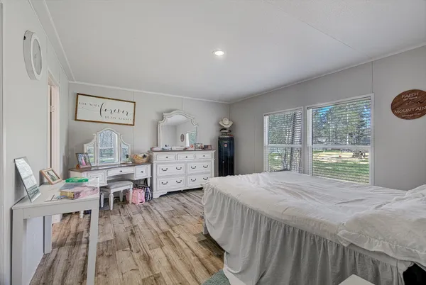 a bedroom with a bed and a large window