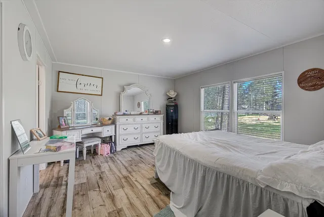 a bedroom with a bed and a large window