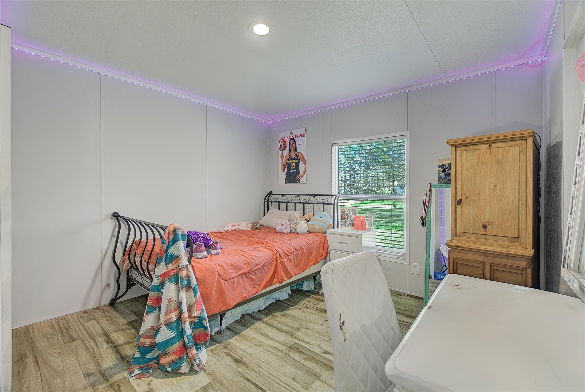 650 County Road 2219 Cleveland, TX 77327 - Photo 21 of 39 a bedroom with furniture and a wooden floor