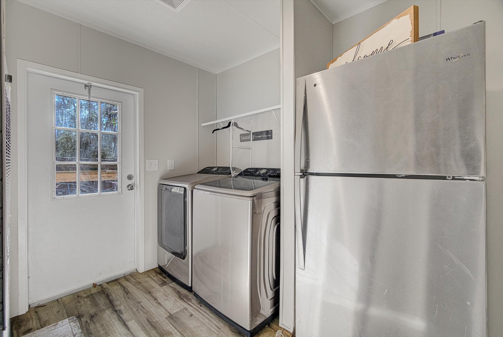 650 County Road 2219 Cleveland, TX 77327 - Photo 30 of 39 a utility room with wooden floor and a window