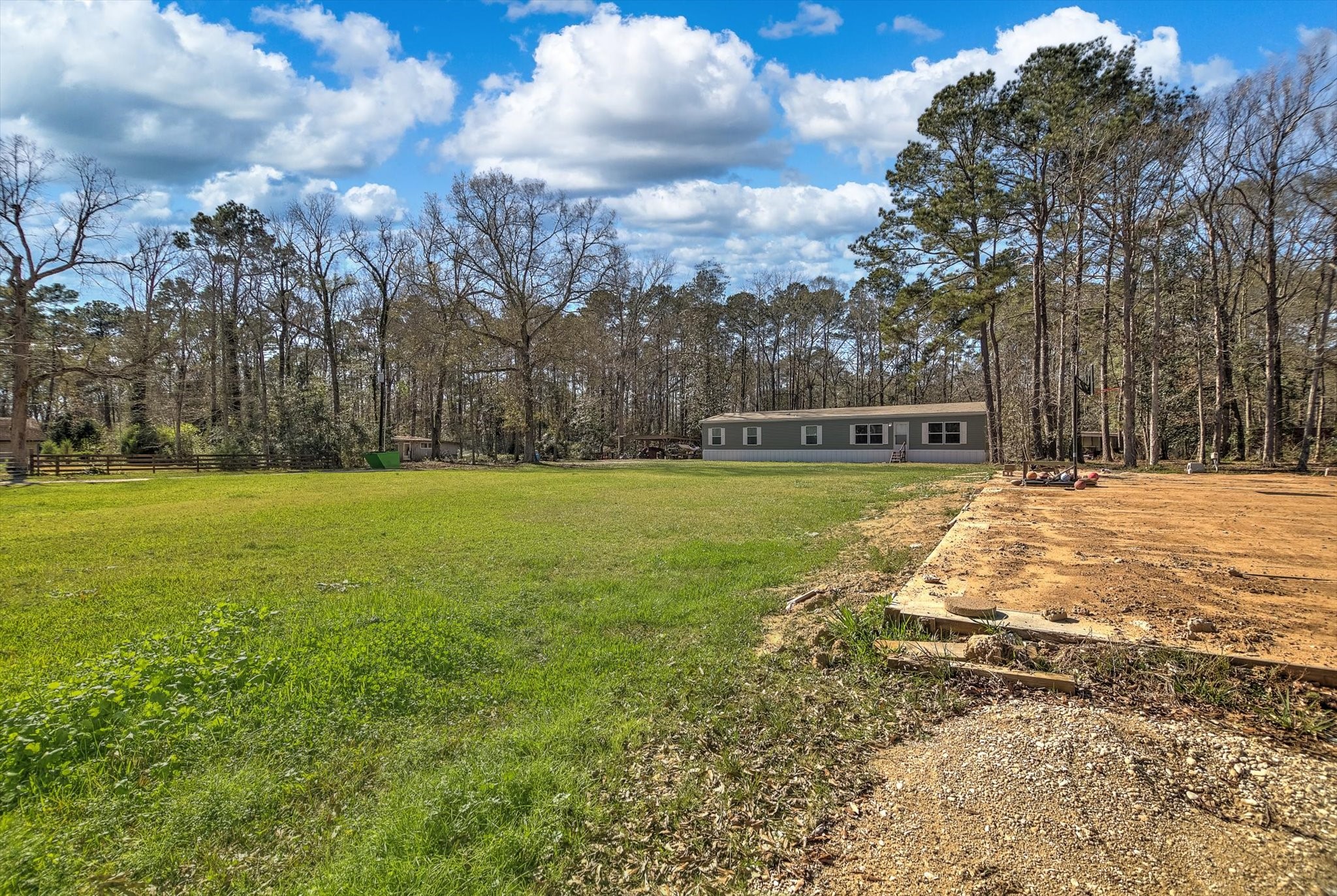 650 County Road 2219 Cleveland, TX 77327 - Photo 38 of 39 a view of yard with swimming pool and green space