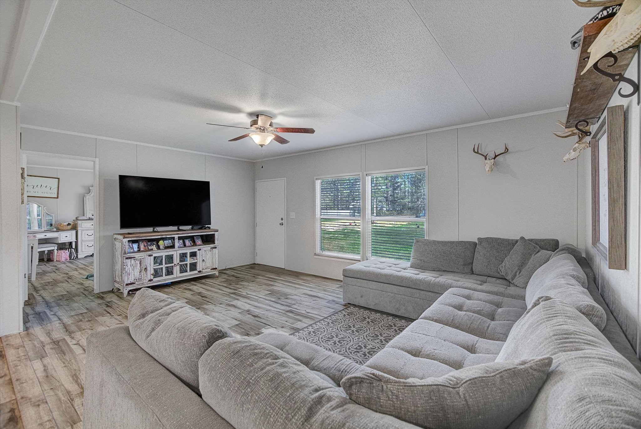650 County Road 2219 Cleveland, TX 77327 - Photo 4 of 39 a living room with furniture and a flat screen tv