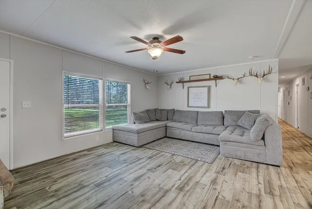 a living room with furniture and a large window
