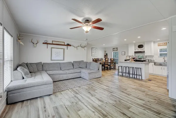 a living room with furniture and kitchen view