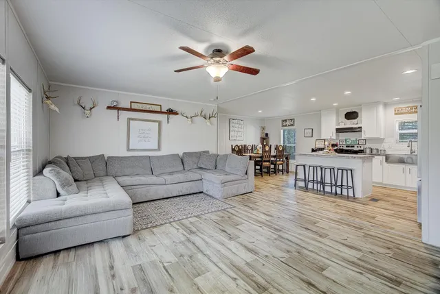 a living room with furniture and kitchen view