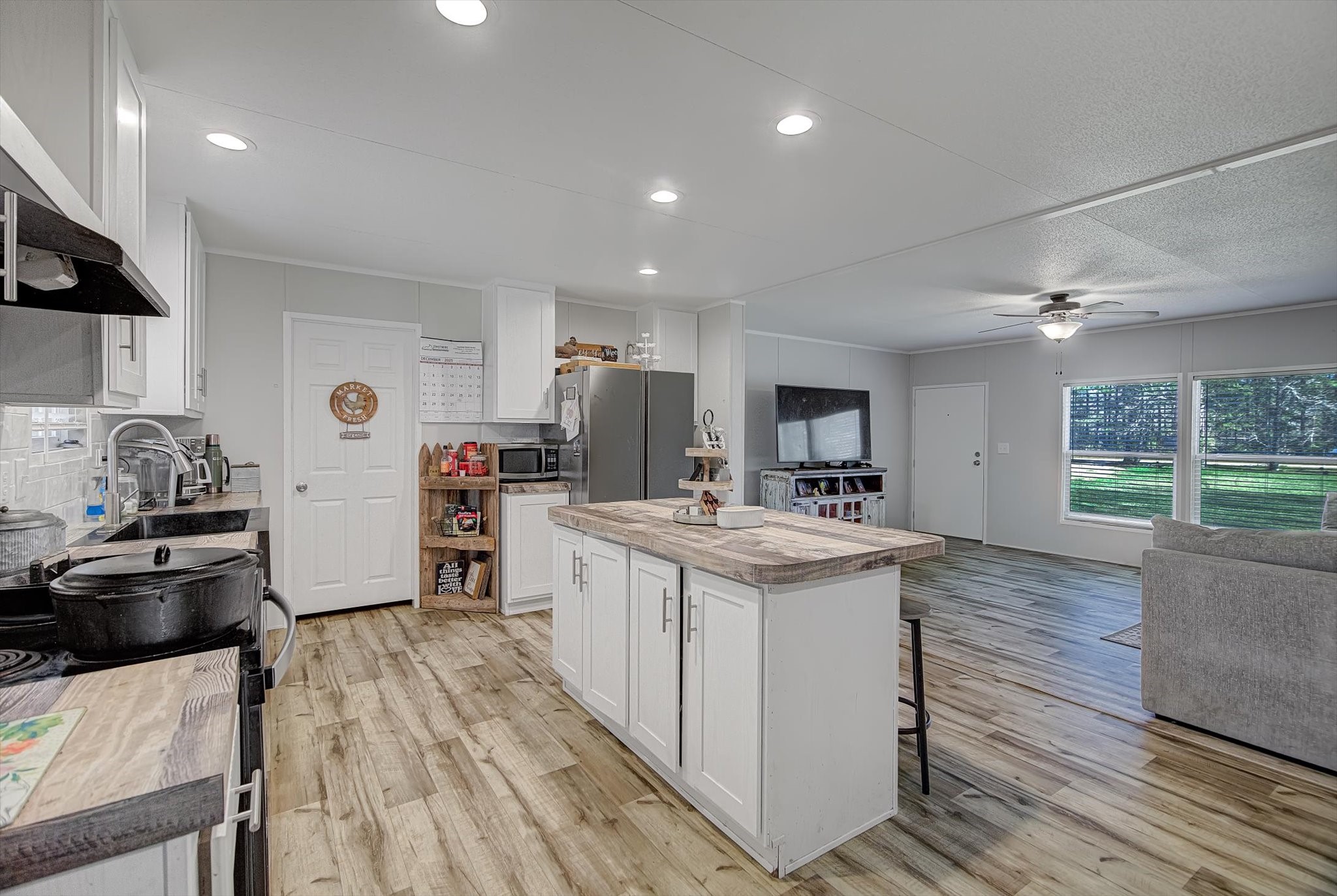 650 County Road 2219 Cleveland, TX 77327 - Photo 9 of 39 a kitchen with stainless steel appliances granite countertop a stove and a refrigerator