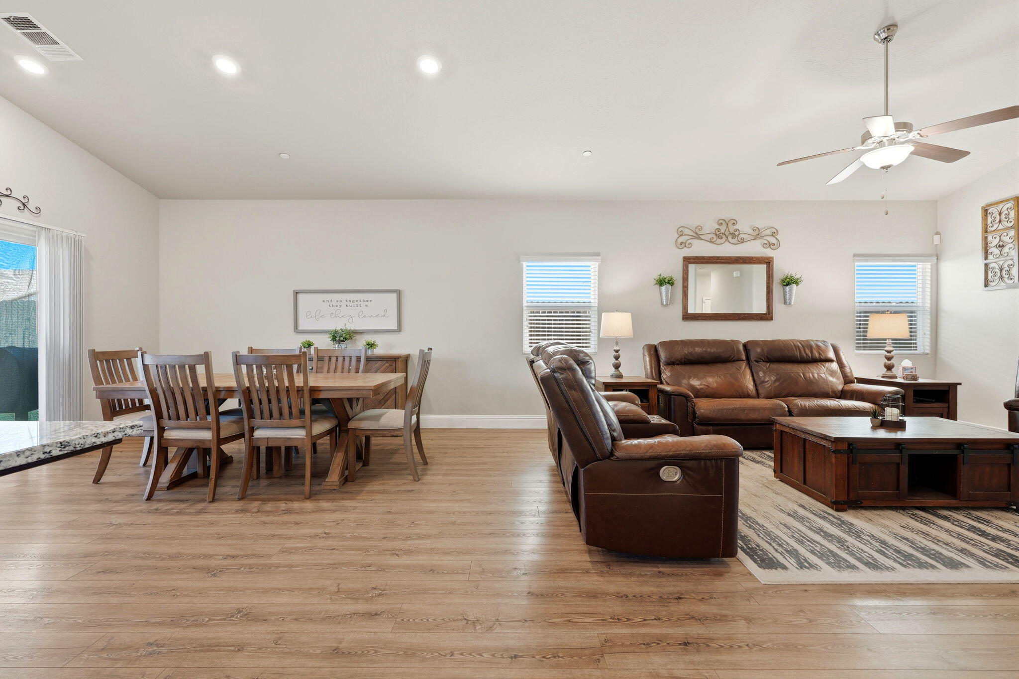 756 Strada Street Lemoore, CA 93245 - Photo 11 of 53 a living room with furniture wooden floor and a dining table