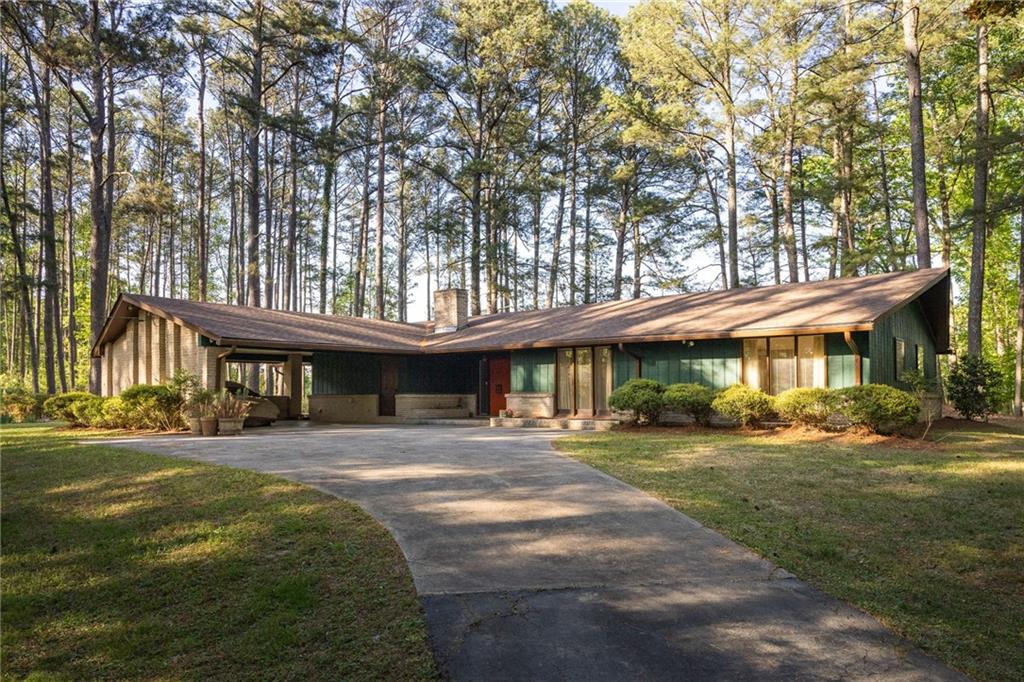 8355 Cedar Grove Road Fairburn, GA 30213 - Photo 1 of 1 a front view of a building with a garden