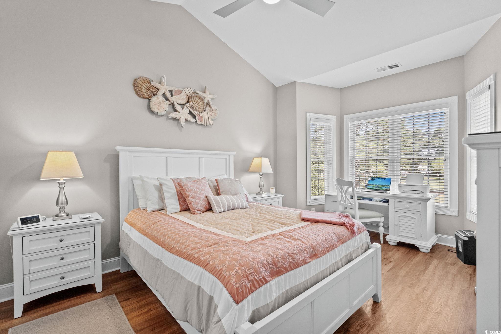 4885 Magnolia Pointe Lane, Unit 304 Myrtle Beach, SC 29577 - Photo 17 of 39 Bedroom with vaulted ceiling, wood finished floors, and ceiling fan
