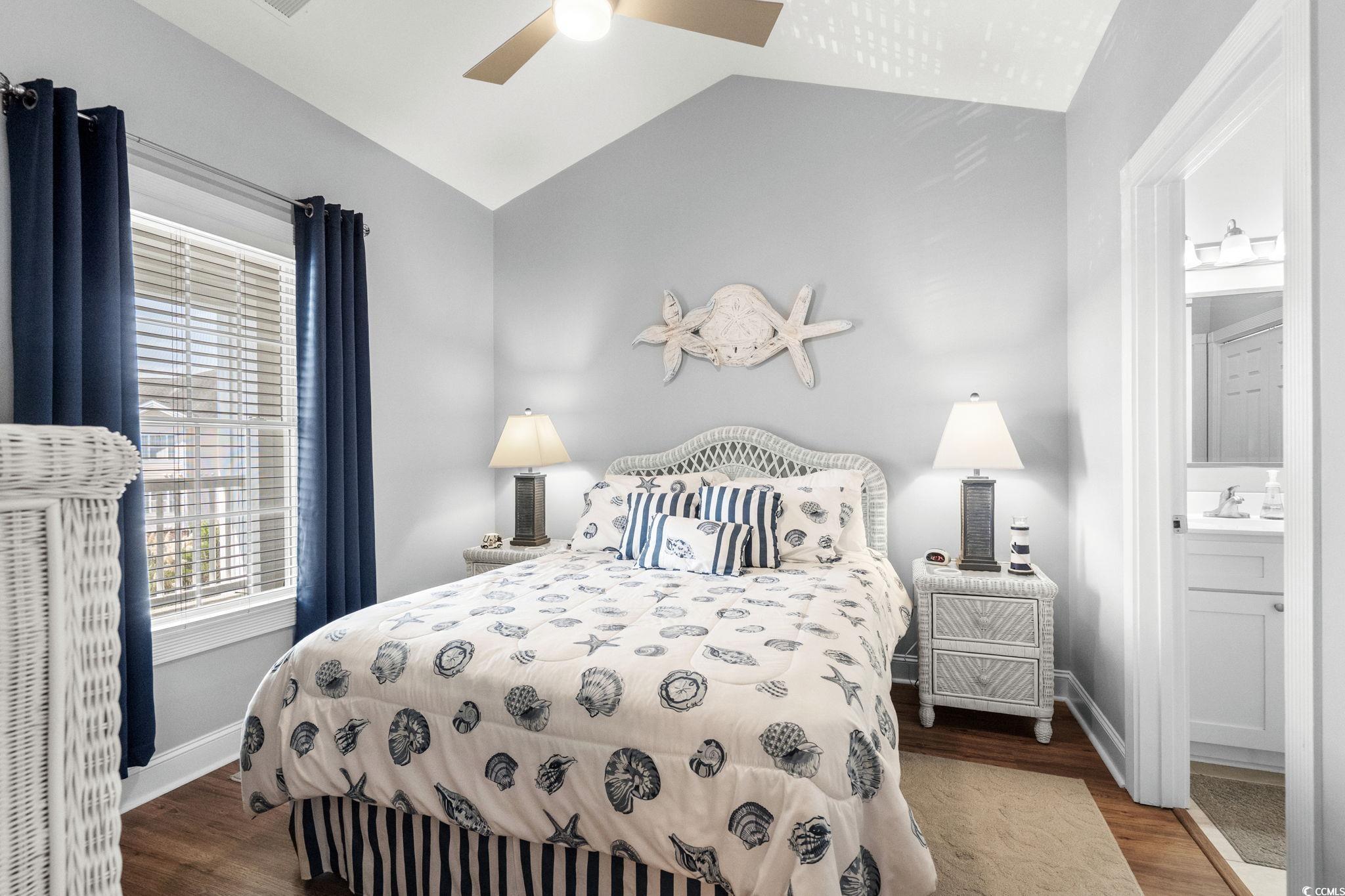 4885 Magnolia Pointe Lane, Unit 304 Myrtle Beach, SC 29577 - Photo 21 of 39 Bedroom with dark wood-style flooring, lofted ceiling, a ceiling fan, and ensuite bath