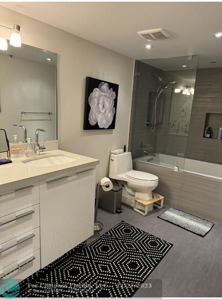 8877 Collins Avenue, Unit 307 Surfside, FL 33154 - Photo 11 of 15 a bathroom with a sink mirror toilet and shower