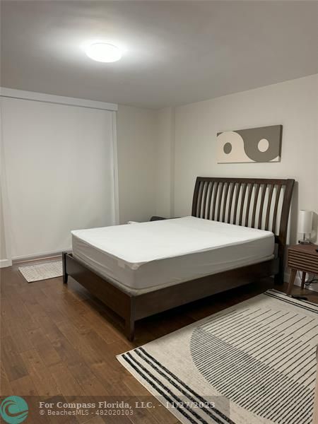 8877 Collins Avenue, Unit 307 Surfside, FL 33154 - Photo 10 of 15 a bedroom with a bed and a table