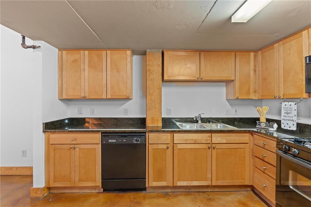 644 Wells Street Southwest, Unit 10 Atlanta, GA 30310 - Photo 25 of 46 a kitchen with granite countertop cabinets stainless steel appliances and a counter space