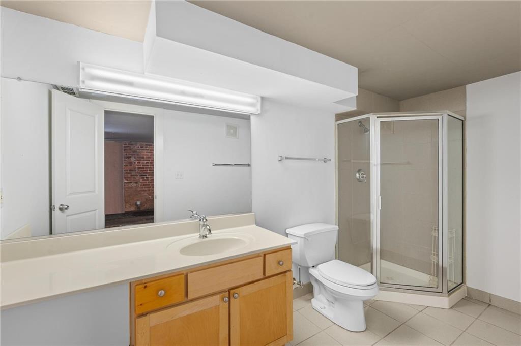 644 Wells Street Southwest, Unit 10 Atlanta, GA 30310 - Photo 29 of 46 a bathroom with a sink a toilet and shower
