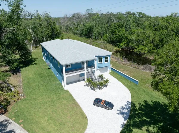 an aerial view of a house with yard