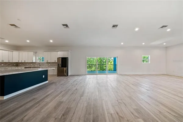 a view of kitchen with stove and cabinets