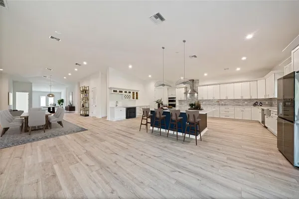 a living room with furniture and kitchen view